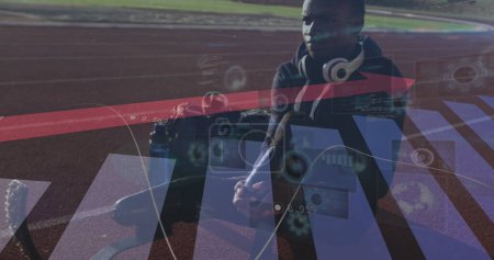 Photo for Image of statistics with arrow over disabled male athlete with running blades on racing track. global sports, competition, disability and digital interface concept digitally generated image. - Royalty Free Image