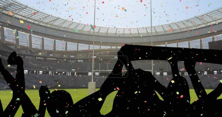 Colorful confetti falling against silhouette of fans cheering and sports stadium in background. sports competition and tournament concept