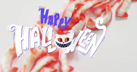 Téléchargez les photos : Image de texte d'Halloween heureux avec chat sur les dents bonbons. tradition halloween et concept de célébration image générée numériquement. - en image libre de droit