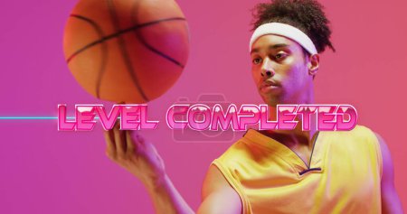 Photo for Image of level completed text over neon pattern and biracial basketball player. Sports, competition, image game and communication concept digitally generated image. - Royalty Free Image