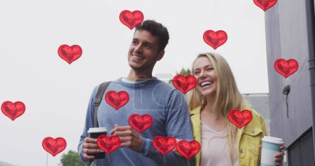 Photo for Image of heart icons floating over happy caucasian couple walking and drinking takeaway coffee. social media and communication interface concept digitally generated image. - Royalty Free Image