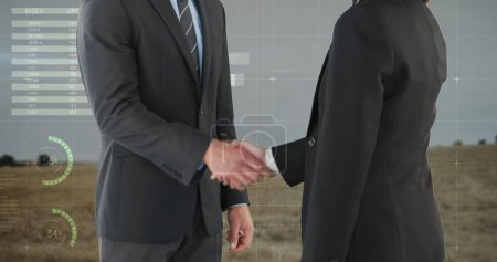 Photo for Digital composite of handshake between a businessman and a businesswoman both wearing suits. The background is a wide open field with digital graphs and statistic - Royalty Free Image