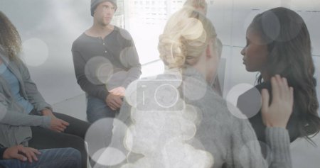 Image of light spots over diverse people participating in group therapy. Mental health, therapy and healthcare concept digitally generated image.