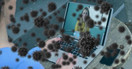 Image of covid 19 cells over businesswoman on laptop image call. global covid 19 pandemic concept digitally generated image.
