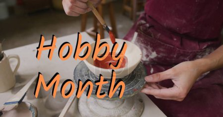 Image of hobby month over woman in pottery workshop. hobby, interest and leisure time concept digitally generated image.