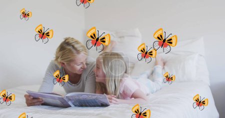 Image of butterflies over happy caucasian mother and daughter reading book in bed. family life, childhood, love and care concept digitally generated image.