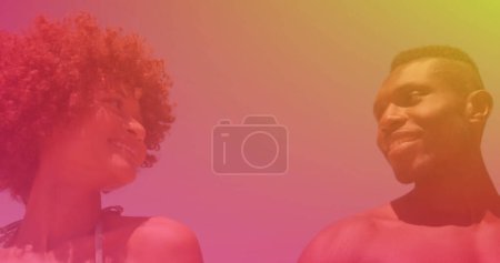 Téléchargez les photos : Image d'un couple afro-américain à la plage tenant la main et souriant, sur une lumière colorée. passer du temps libre ensemble, des vacances heureuses et du temps libre, image générée numériquement. - en image libre de droit