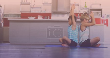 Photo for Asian and caucasian brothers performing yoga in the kitchen at home. national siblings day awareness concept - Royalty Free Image