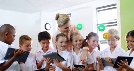 Photo for Image of colorful icons over diverse schoolchildren and teacher using tablets. Global social media, icons and digital interface concept digitally generated image. - Royalty Free Image
