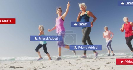 Photo for Image of social media notifications, over happy women running on beach. social media, positive feelings, wellbeing and communication network concept, digitally generated image. - Royalty Free Image