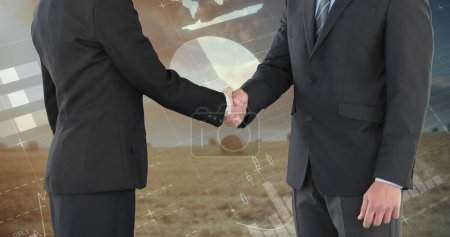 Photo for Close up of a handshake between a businesswoman and a businessman. Digital image of graphs and statistics are seen running on a background of a wide field - Royalty Free Image