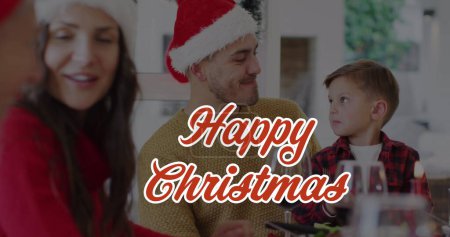 Photo for Image of happy christmas text over caucasian family wearing santa hats. Christmas, tradition and celebration concept digitally generated image. - Royalty Free Image