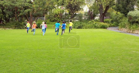 Photo for Image of back to school text over schoolchildren playing outdoors. education, development and learning concept digitally generated image. - Royalty Free Image