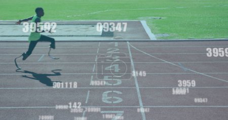 Photo for Image of numbers changing over disabled male athlete with running blades on racing track. global sports, competition, disability and digital interface concept digitally generated image. - Royalty Free Image