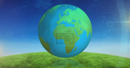 Bild eines blauen und grünen Globus, der sich über Himmel und Graslandschaft dreht. Umwelt, Verbindungen, digitale Schnittstelle und Technologiekonzept digital erzeugtes Bild.