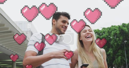 Téléchargez les photos : Image d'icônes du cœur flottant sur un couple caucasien heureux parlant et utilisant un smartphone. concept d'interface de communication et de médias sociaux image générée numériquement. - en image libre de droit
