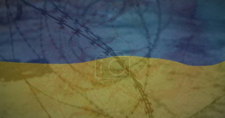 Image of flag of ukraine over field and barbed wire. ukraine crisis and international politics concept digitally generated image.
