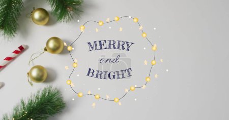 Photo for Image of merry and bright text over decorations. Christmas and digital interface concept digitally generated image. - Royalty Free Image
