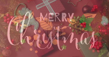 Image of christmas greetings text over christmas presents and decorations. Christmas, festivity, celebration and tradition concept digitally generated image.
