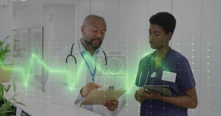 Photo for Image of vital signs monitor over african american female and male doctor talking in hospital. Medical and healthcare services concept digitally generated image. - Royalty Free Image