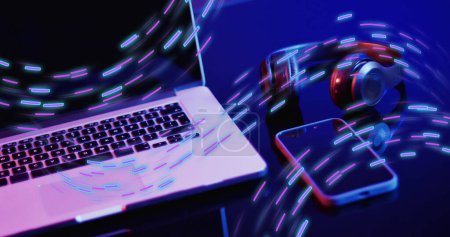Photo for Image of neon light trails over image game computer equipment. Global image game, digital interface, data processing and connections concept digitally generated image. - Royalty Free Image