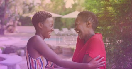 Photo for Two african american sisters hugging each other at a resort. national siblings day awareness concept - Royalty Free Image