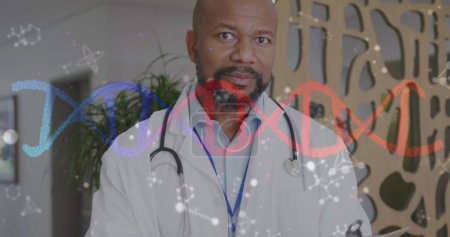 Photo for Image of dna strand and molecules over smiling african american male doctor in hospital. Medical and healthcare services concept digitally generated image. - Royalty Free Image