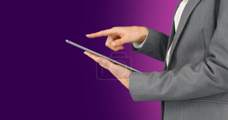 Photo for Image of caucasian businesswoman using tablet on purple background. Global business and digital interface concept digitally generated image. - Royalty Free Image