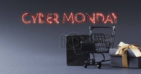 Photo for Image of cyber monday text over shopping trolley and gifts. Sales, retail, cyber shopping, digital interface, communication, computing and data processing concept digitally generated image. - Royalty Free Image