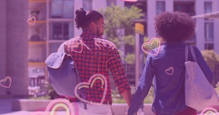 Photo for Multiple pink heart icons floating against african american couple holding hands while walking. love and relationship concept - Royalty Free Image
