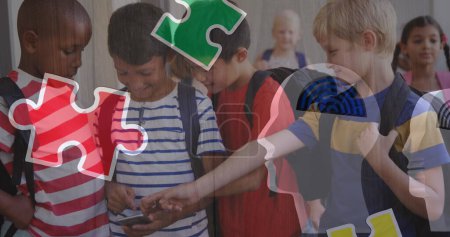 Photo for Image of puzzle pieces over diverse schoolchildren using smartphone. autism awareness month and celebration concept digitally generated image. - Royalty Free Image