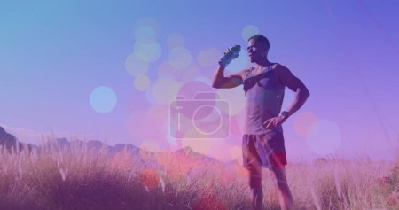 Image of colourful spots over african american man. global sport and digital interface concept digitally generated image.