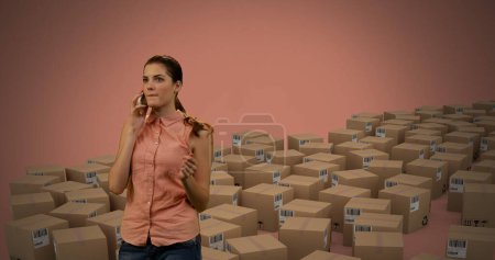 Photo for Image of woman talking on smartphone with boxes on orange background. global shipping and technology concept digitally generated image. - Royalty Free Image