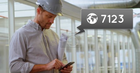 Side view of a Caucasian engineer standing outside an office holding plans in his arm while texting. Beside him is a digital image of a message bubble with a notifications icon increasing in count