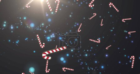 Mehrere Zuckerstangen-Symbole fallen gegen blaue Lichtpunkte auf schwarzem Hintergrund. Weihnachtsfeier und Festkonzept