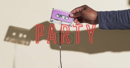 Photo for Image of party text over hand holding tape on beige background. Technology, retro and music concept, digitally generated image. - Royalty Free Image