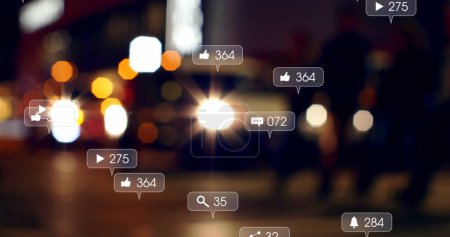 Image of social media icons and numbers over out of focus city lights. global social media, networking, connections and digital interface concept digitally generated image.