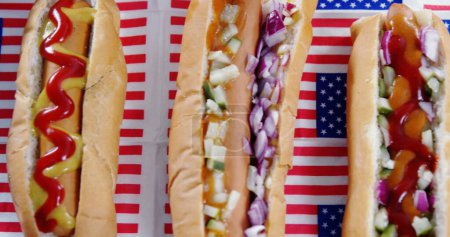 Photo for Image of white and red stripes and human silhouette over hot dogs. presidents day, independence day and american patriotism concept digitally generated image. - Royalty Free Image