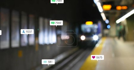 Image of social media icons and numbers over out of focus train platform. global social media, networking, connections and digital interface concept digitally generated image.
