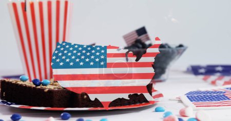 Image of usa map in colours on usa flag over cakes and desserts. presidents day, independence day and american patriotism concept digitally generated image.