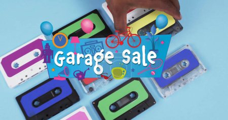 Photo for Image of garage sale text over hand holding tape on blue background. Technology, retro and music concept, digitally generated image. - Royalty Free Image