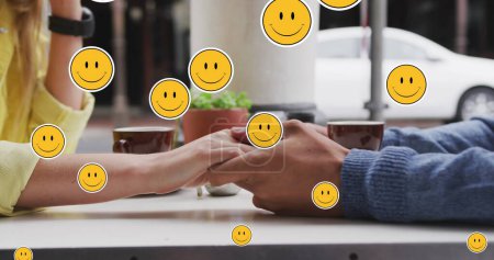 Photo for Image of digital emoji icons floating over caucasian couple holding hands. social media and communication interface concept digitally generated image. - Royalty Free Image