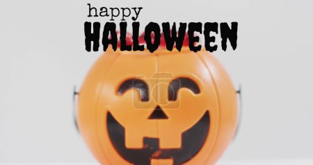 Photo for Trick or treat text banner against pumpkin shaped bucket full of halloween candies. halloween festivity and celebration concept - Royalty Free Image