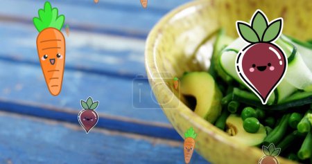 Photo for Image of carrot and beetroot icons falling over bowl of fruit salad on blue wooden table. Vegan, organic and healthy food concept - Royalty Free Image