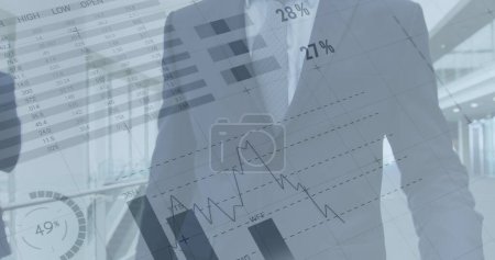 Photo for Image of financial data and graphs over caucasian businessman walking in office. business, finance, economy and technology concept digitally generated image. - Royalty Free Image