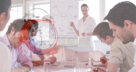 Photo for Image of clock over diverse business people at meeting. global business and digital interface concept digitally generated image. - Royalty Free Image