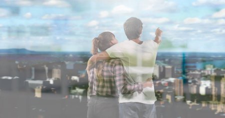 Image of windows over couple embracing looking at cityscape. planning future concept digitally generated image.