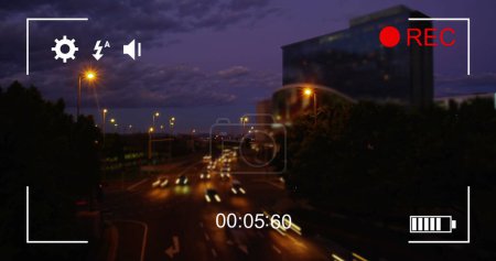 Image of night traffic in fast motion, seen on a screen of a digital camera in record mode with icons and timer 4k
