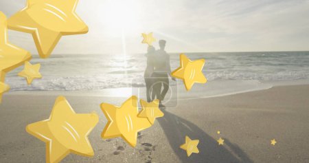 Photo for Image of stars over biracial couple at beach. Christmas, celebration and digital interface concept digitally generated image. - Royalty Free Image