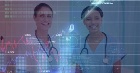 Image of financial data over happy diverse female doctors talking. finance, economy, medicine, health and technology concept digitally generated image.